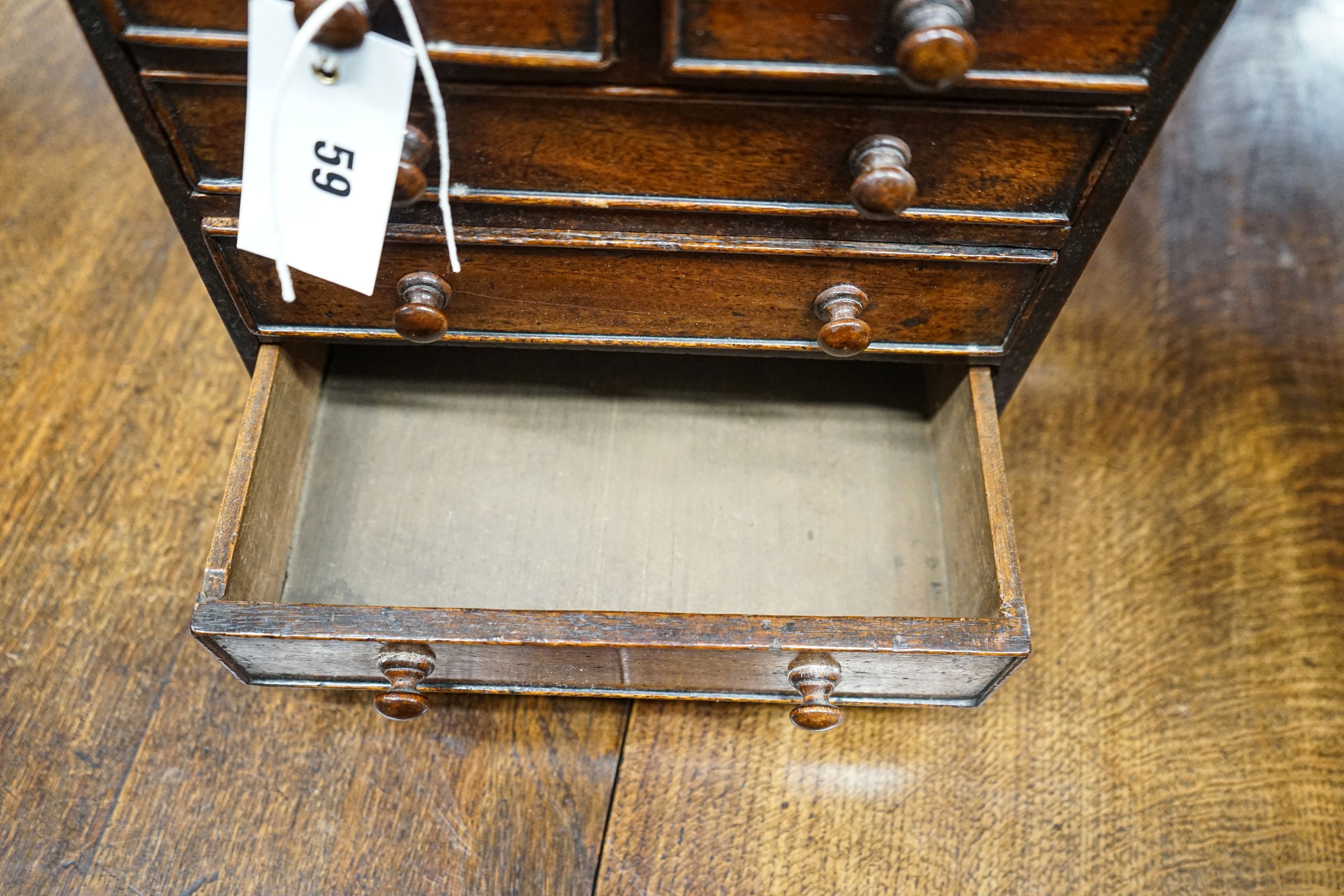 An antique mahogany miniature chest of drawers, width 27cm, depth 16cm, height 27cm